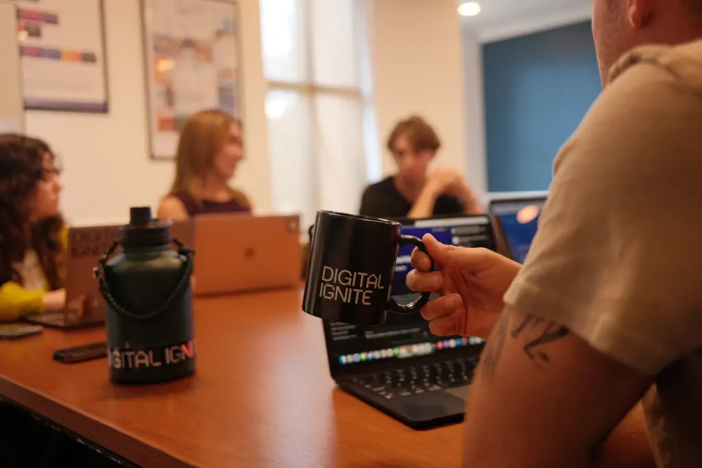 Digital Ignite mug at conference table